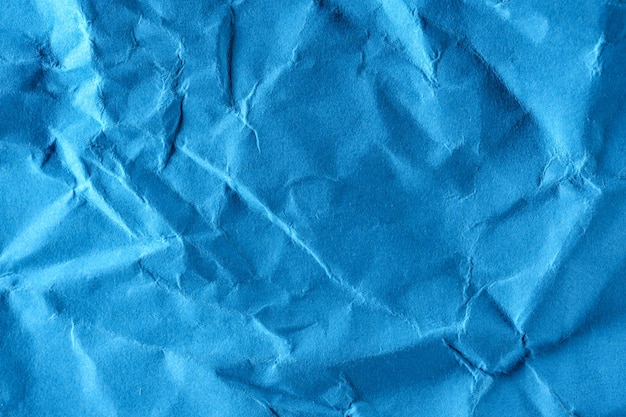 Fondo strutturato di carta da macrofotografia ravvicinata di carta blu stropicciata ad alto dettaglio