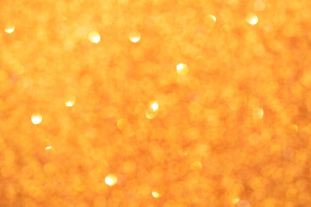 Fondo vago giallo astratto del bokeh. Luci brillanti scintillanti. Sfondo festivo e celebrativo per il design di vacanze, natale e capodanno, stock photo