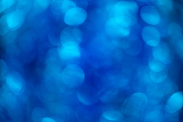 Fondo vago lucido blu del lamé di Natale del bokeh. Modello, trama, posto per il testo.