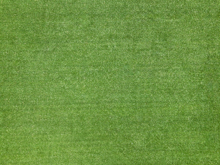 Foto fondo verde di struttura dell'erba falsa del campo di football americano