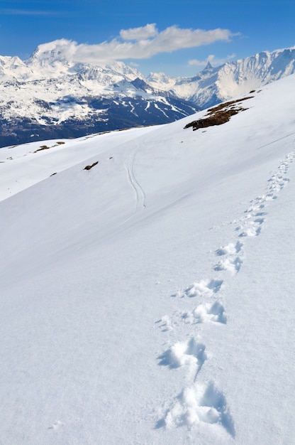 Footsprints sulla neve con vista sulla montagna di picco