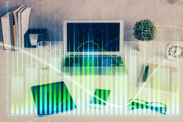 forex market graph hologram and personal computer on background double exposure concept of investment