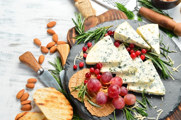 Formaggio erborinato con muffa su un piatto con spuntini. Stile rustico. Spazio di copia gratuito.