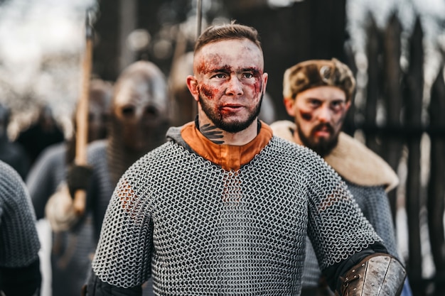 Foto dei cavalieri in armatura con le spade durante la guerra. Emozioni malvagie di un guerriero che va a combattere con la spada