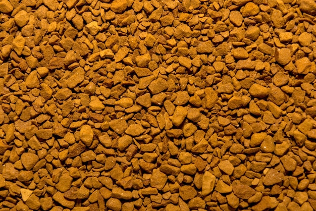 Foto della consistenza di close-up di un bellissimo fondo di caffè istantaneo marrone macinato