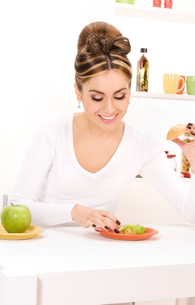 foto di donna con mela verde e panino