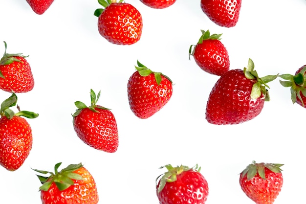 Foto luminosa di fragole sul getto bacche estive su bianco Fragole dolci