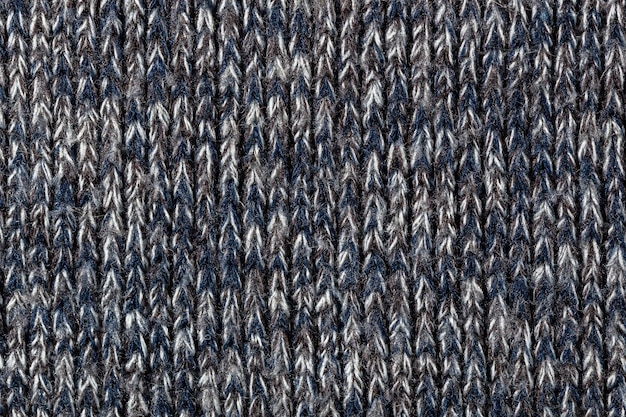 Foto macro di caldo maglione in poliestere grigio melange con struttura anche verticale