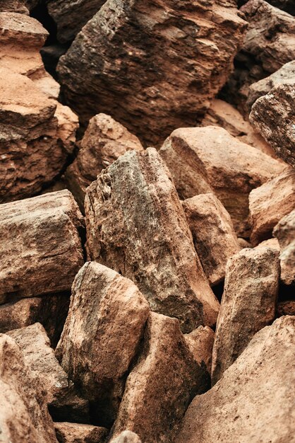 Foto ravvicinata verticale di grandi pietre di montagna marroni. Gruppo di pietre di roccia granitica. Trama e sfondo. concetto di natura.