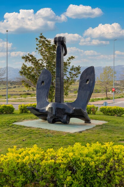 Foto verticale di una statua in ferro di un'ancora in un parco a Madrid