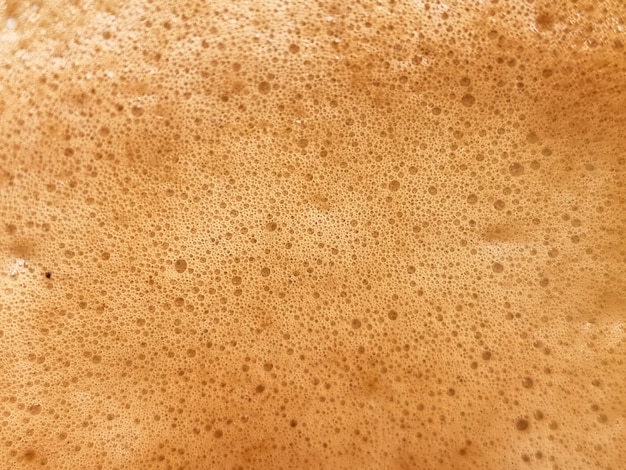 Fotografia astratta del primo piano del fondo e delle strutture del caffè del latte caldo delle bolle