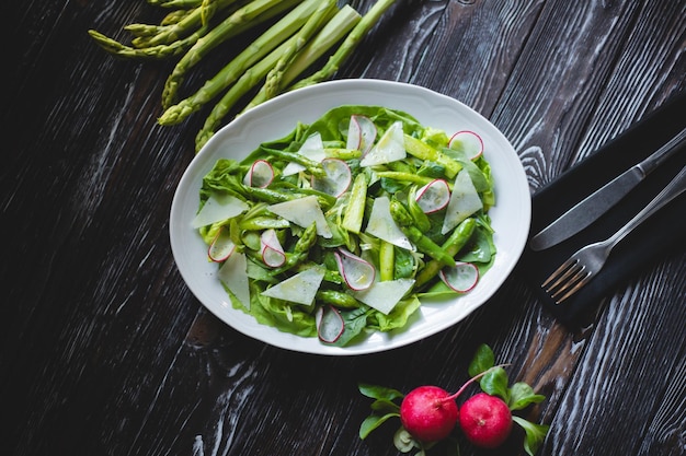 Fotografia di cibo Insalata verde con verdure fresche, asparagi e ravanelli