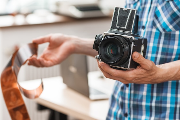 Fotografo maschio con fotocamera retrò e pellicola