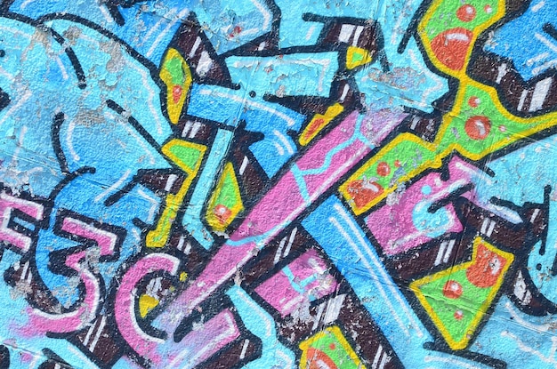 Fragmento di disegni di graffiti La vecchia parete decorata con macchie di vernice nello stile della cultura dell'arte di strada Texture di sfondo colorate in toni freddi