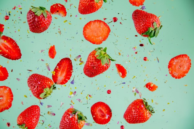 Fragola di stagione primaverile in aria sulla parete verde. Sopra la vista