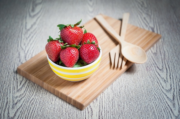 Fragola fresca e succo sul tavolo di legno. distesa piatta.