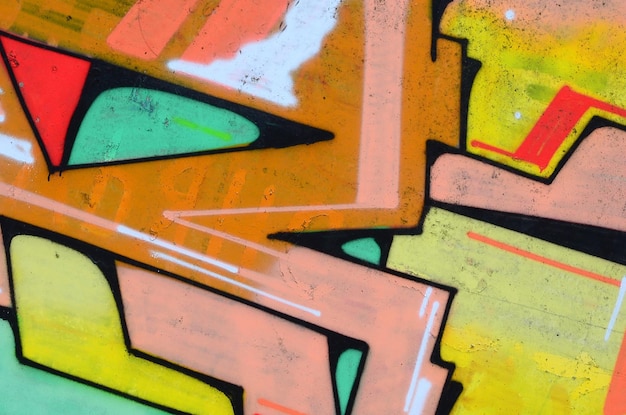 Frammento di disegni di graffiti Il vecchio muro decorato con macchie di vernice nello stile della cultura dell'arte di strada Trama di sfondo colorato