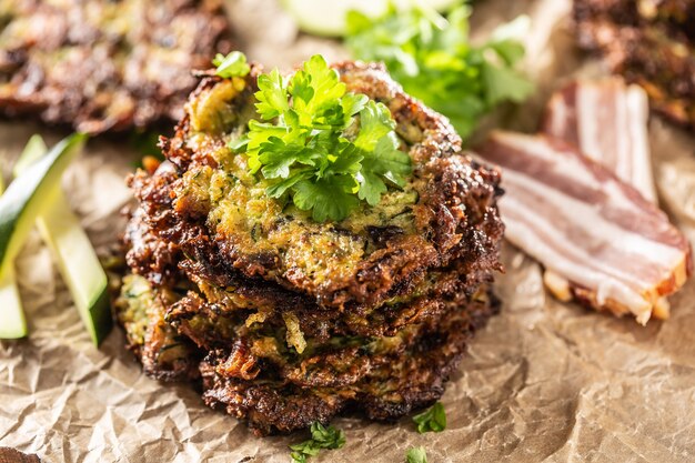 Frittelle croccanti di zucchine con pancetta prezzemolo erbe e altri ingredienti.