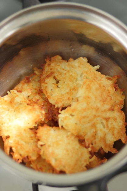 Frittelle di patate fatte in casa pronte in una pentola in una cucina domestica Concetto di cibo vegetariano Primo piano