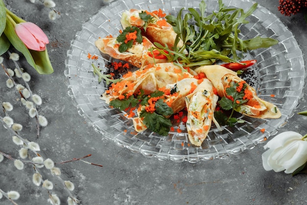 Frittelle sottili con caviale e salmone arrotolate in rotoli