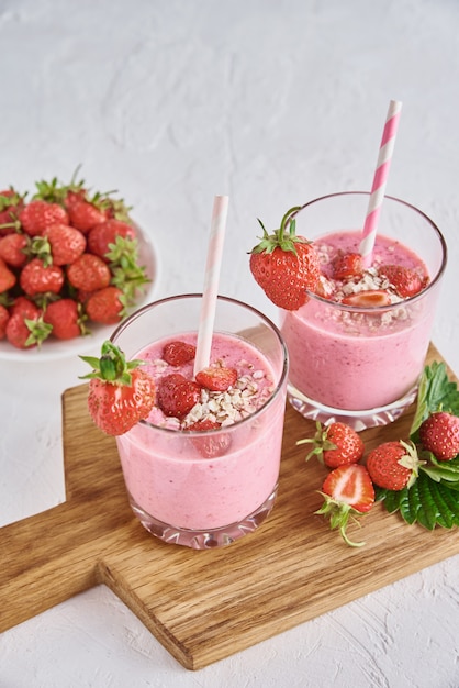 Frullato di latte alla fragola in bicchieri con cannucce