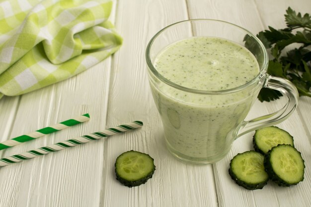 Frullato di yogurt con cetriolo sul legno bianco