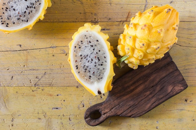 Frutta gialla del drago pitahaya su fondo di legno