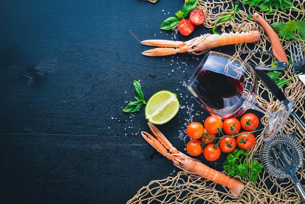 Frutti di mare e un bicchiere di vino su uno sfondo di legno Vista dall'alto Spazio libero per il testo