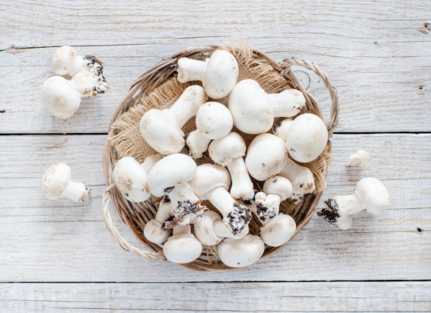 Funghi Champignon su un vecchio tavolo di legno