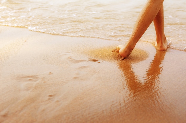 gambe della ragazza sulla spiaggia.