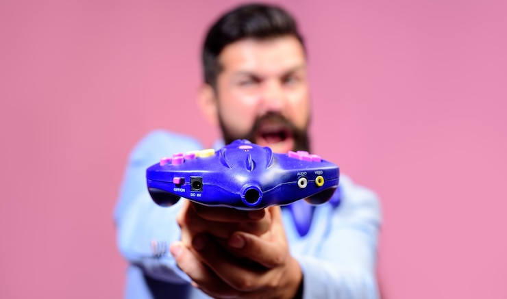 Photo game controller in hand video game controller in gamer hands selective focus electronics industry