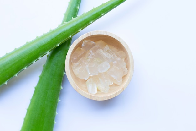 Gel di aloe vera in ciotola di legno su bianco