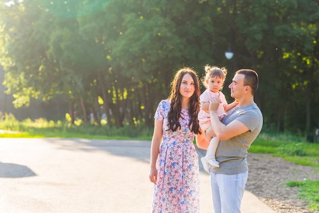 Genitori con bambino nel parco. Madre, padre e figlia