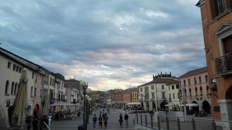 Foto gente che cammina per strada tra gli edifici della città contro il cielo