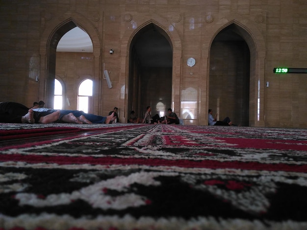 Gente che si rilassa sul tappeto alla moschea
