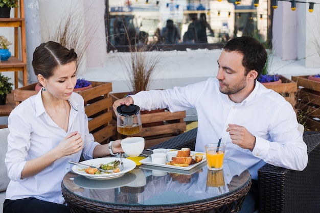 Gente di affari felice durante il pranzo fuori al bar