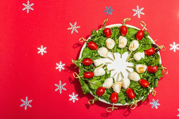 Ghirlanda di charcuterie in tradizionale disegno di colori per il Capodanno con decorazioni natalizie Snack moderno