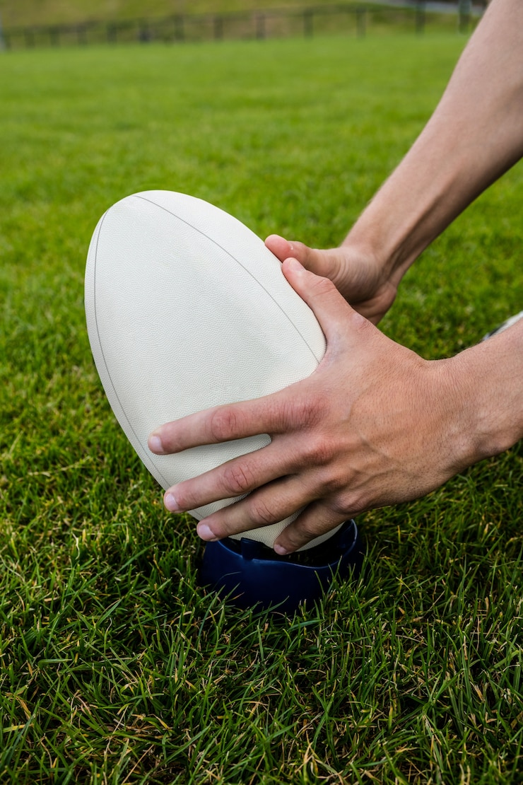 Foto giocatore di rugby che raccoglie palla