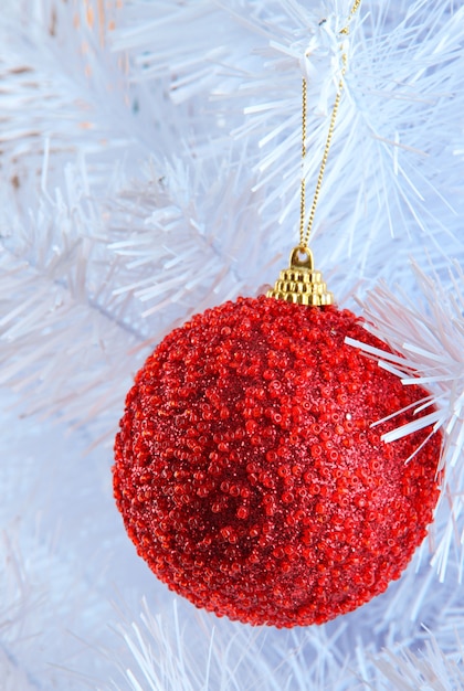 Giocattolo di Natale sul primo piano bianco come la neve dell'albero di Natale isolato su bianco