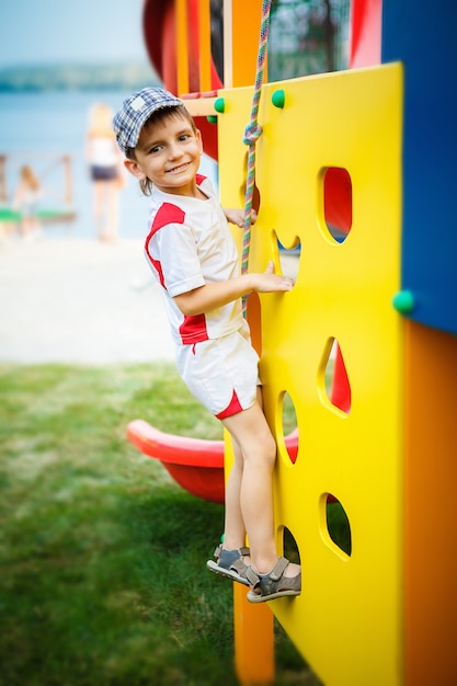 Giochi felici - bel ragazzo nel parco giochi