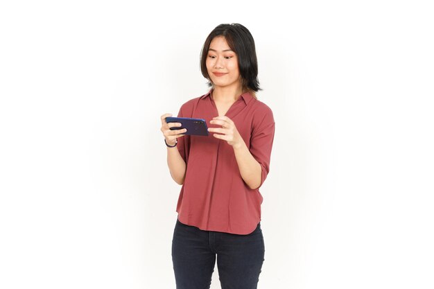 Giochi su smartphone di bella donna asiatica isolata su sfondo bianco