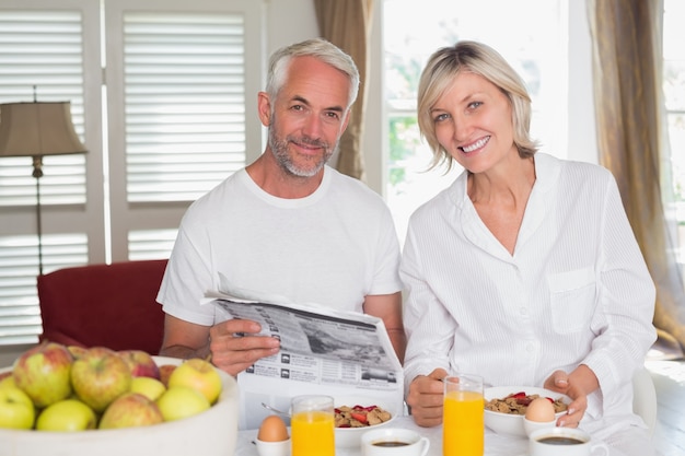 Giornale della lettura delle coppie mentre mangiando prima colazione