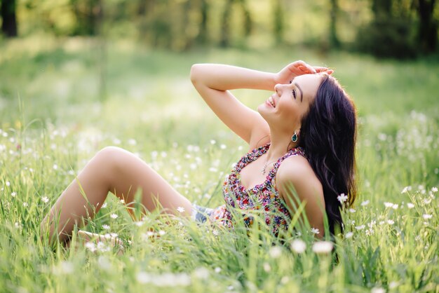 Giornata di sole estivo, una bellissima giovane donna sdraiata sull'erba