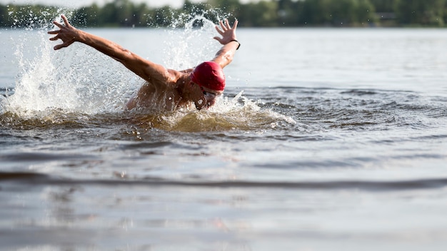 Giovane atleta che nuota nel lago