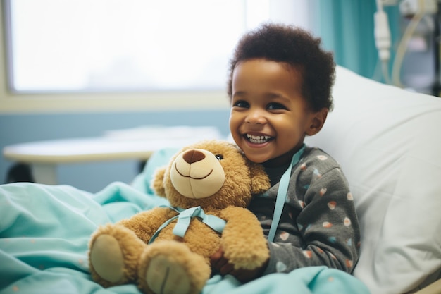 Giovane bambino afroamericano con un orsacchiotto sdraiato su un letto d'ospedale