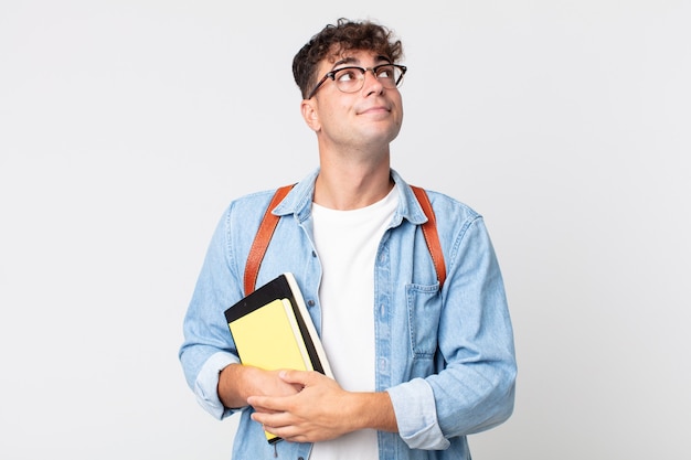 Giovane bell'uomo che scrolla le spalle, sentendosi confuso e incerto. concetto di studente universitario