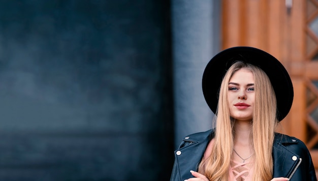 Giovane bella bionda con un cappello nero. Banner con copia spazio