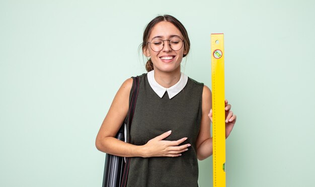 Giovane bella donna che ride ad alta voce per qualche scherzo esilarante. concetto di architettura