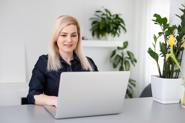 giovane bella donna che utilizza un computer portatile a casa.