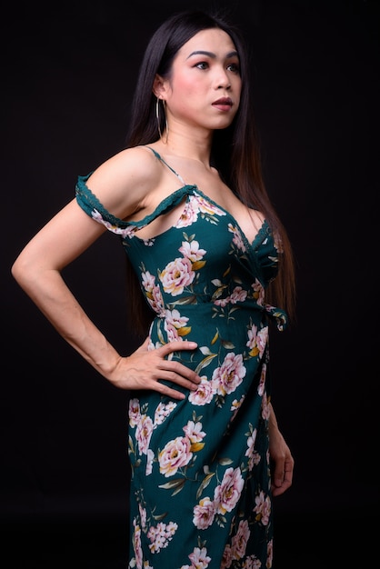 giovane bella donna transgender asiatica contro il nero